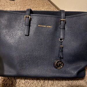 Michael Kors Dark Blue Tote with Gold Accents

• 16.5”W X 10”H X 5.5”D